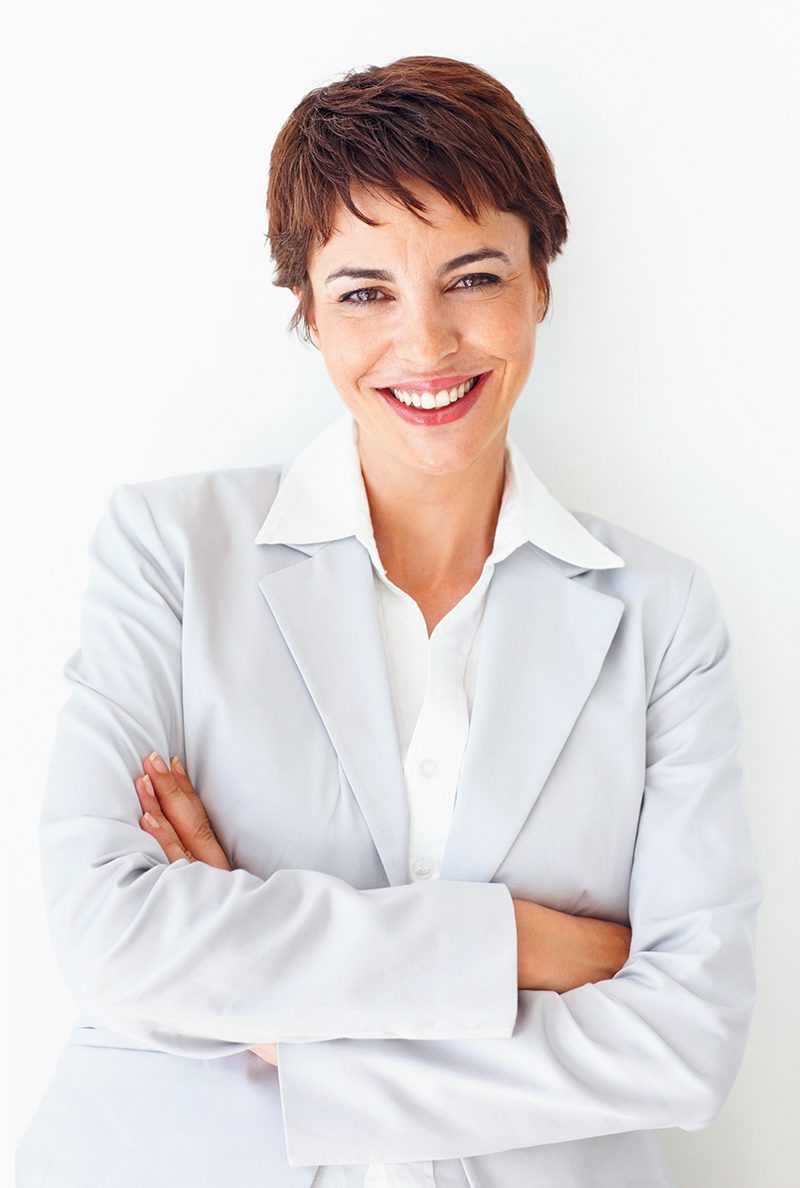 A woman in a white jacket smiling for the camera.