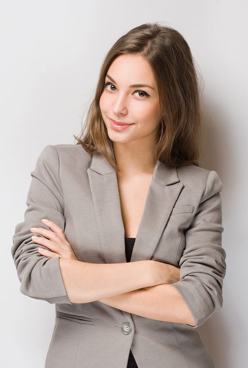 A woman in grey jacket with arms crossed.