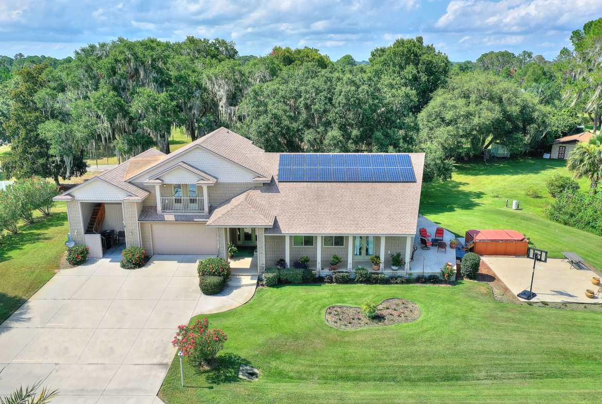 A house with a solar panel on the roof.