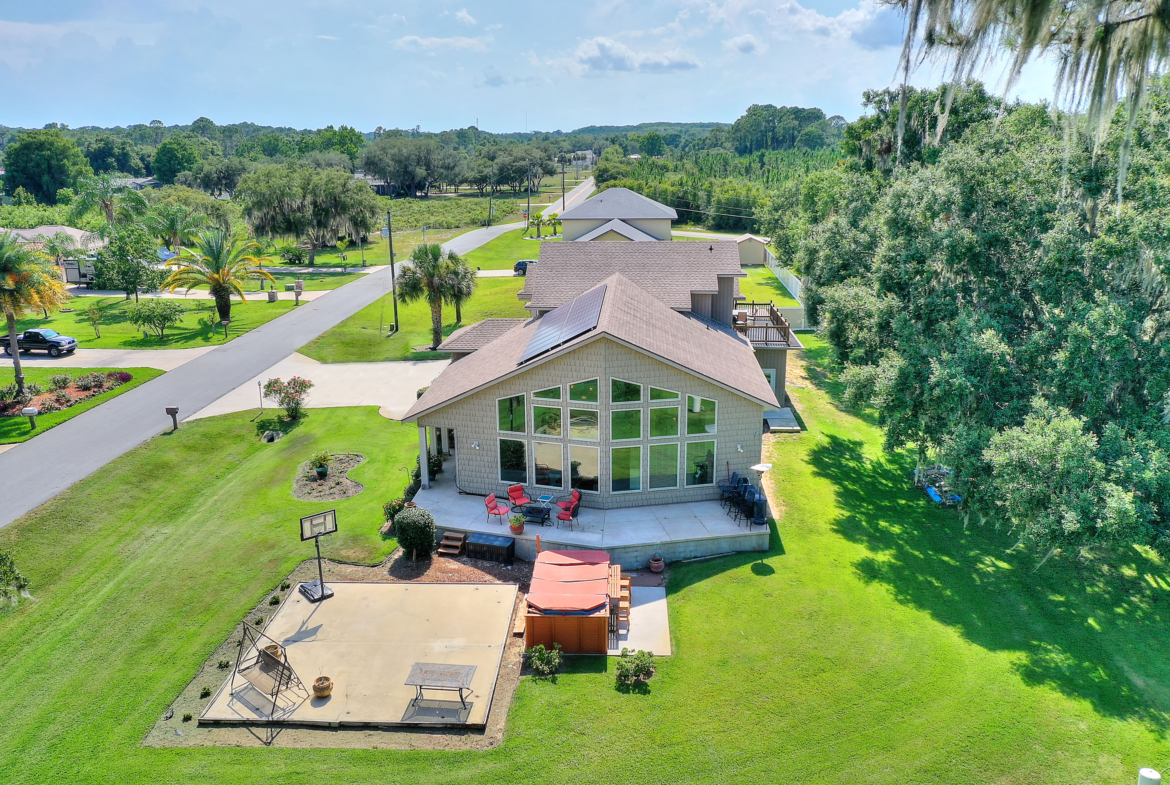 A large house with a big yard and lots of trees