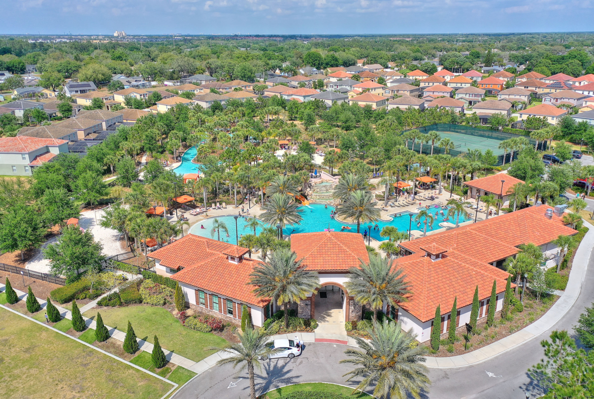 A large pool with many trees and buildings