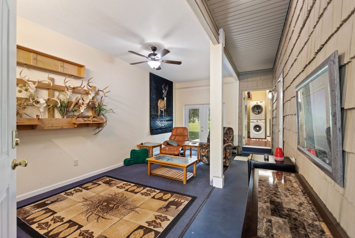 A living room with a rug and a wall hanging