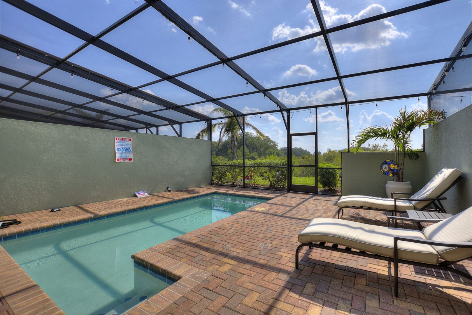 A pool with two chairs and a bench in it