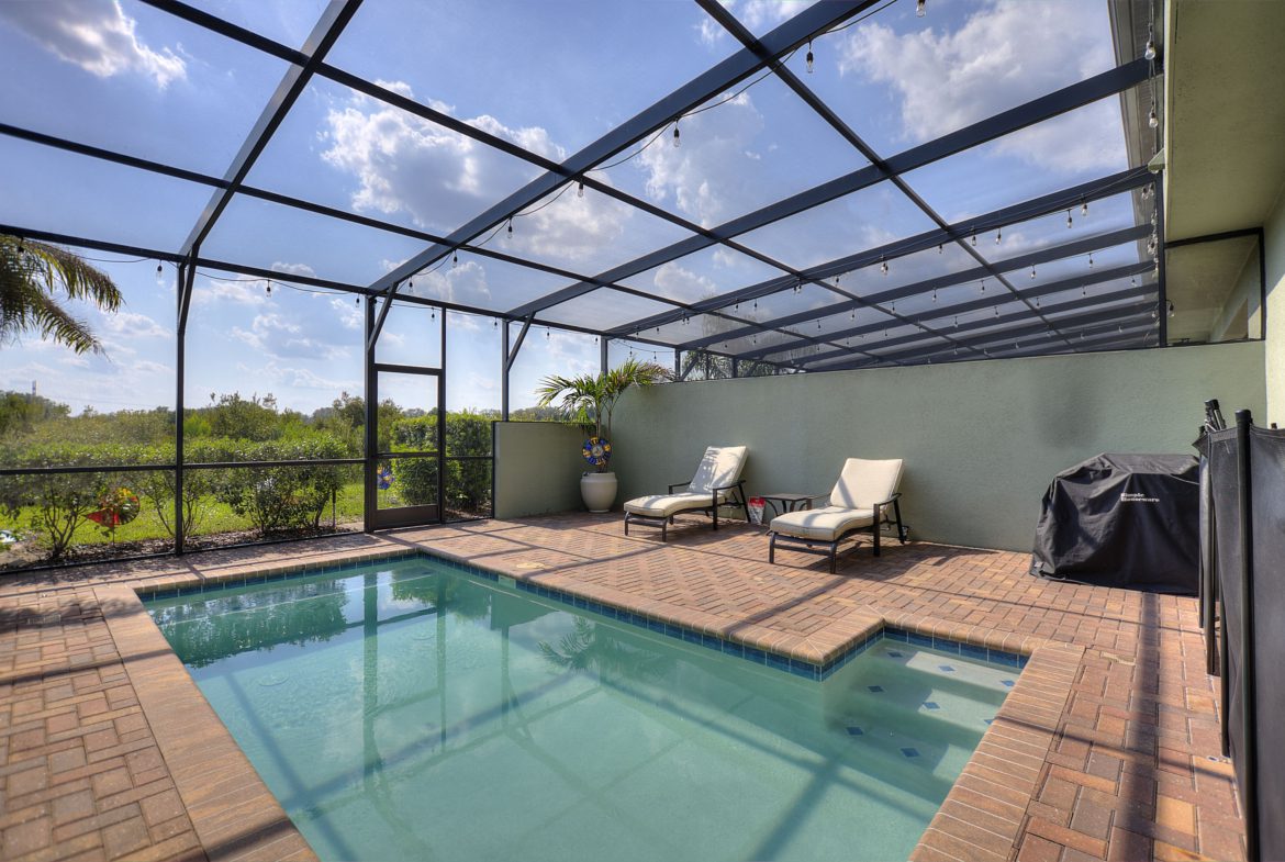 A pool with two chairs and a table in it