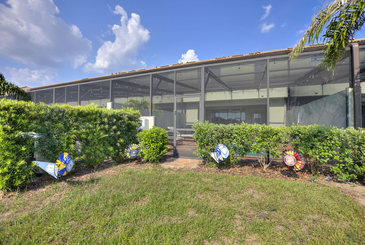 A large building with many bushes in front of it.