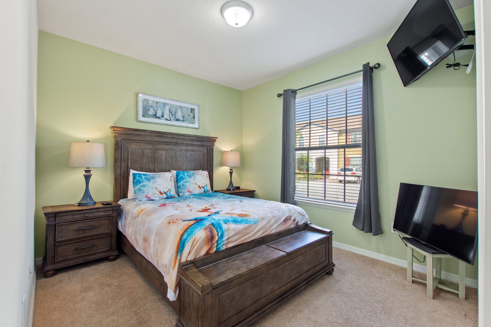 A bedroom with a bed, tv and window.