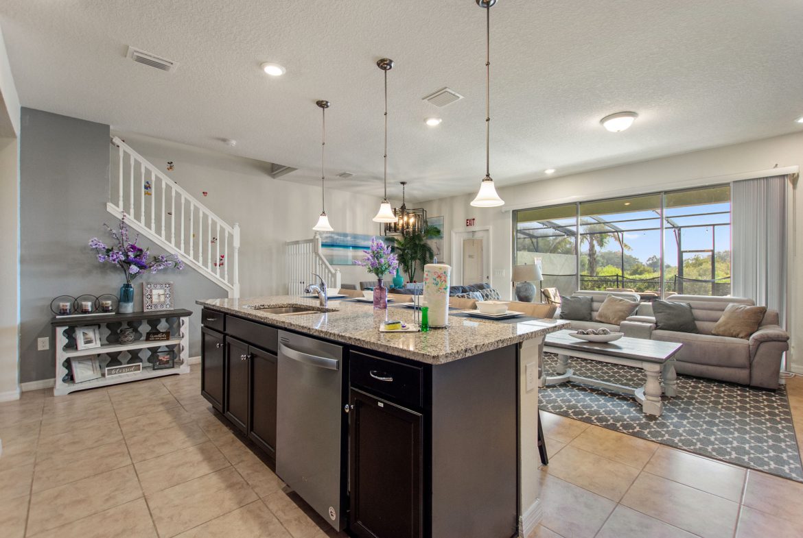 A kitchen with a large island and lots of counter space.