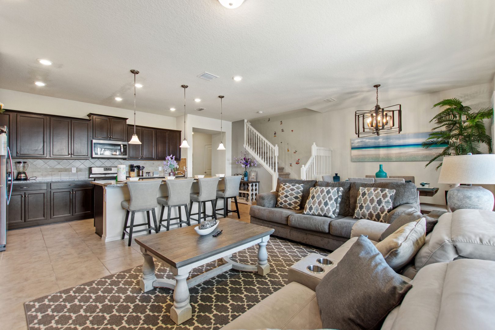 A living room filled with furniture and a kitchen.