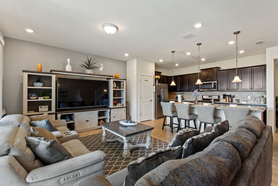 A living room with couches, chairs and tables.