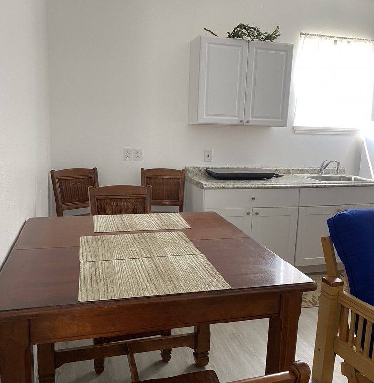 A kitchen with a table and chairs in it