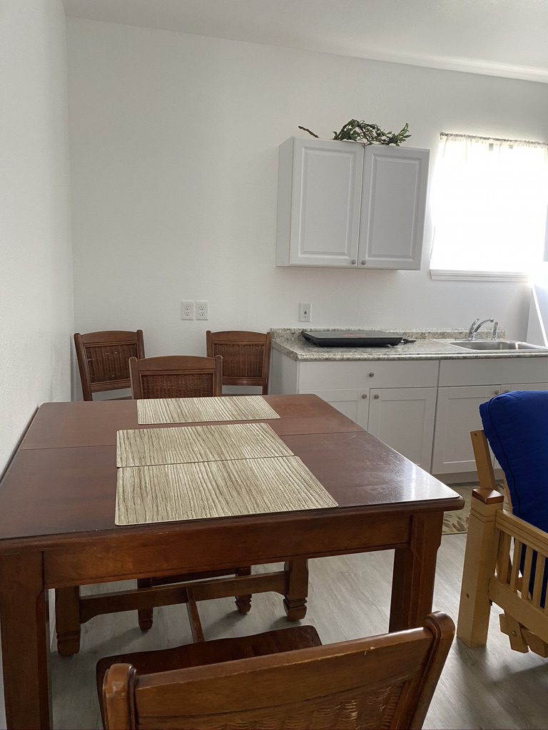 A kitchen with a table and chairs in it