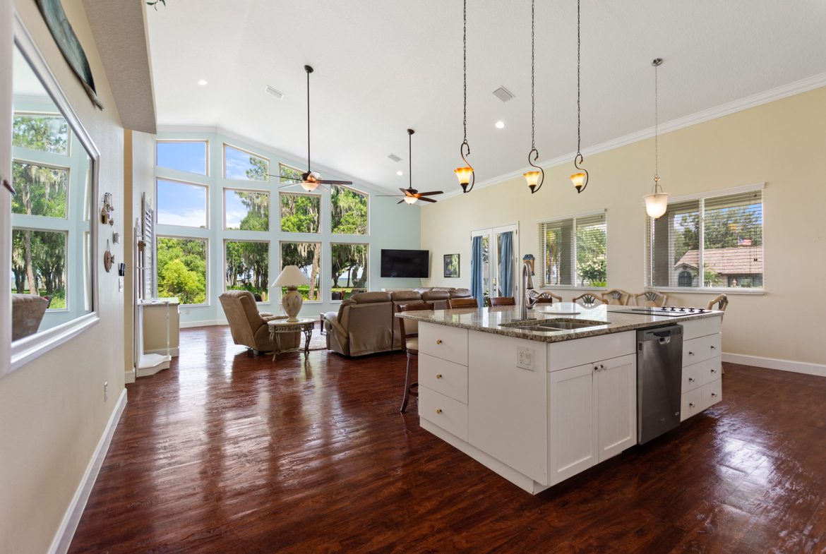 A large open kitchen with a dining room and living room.