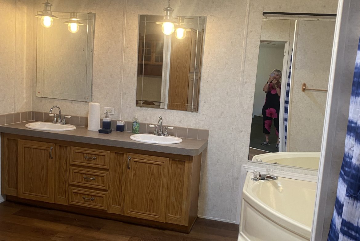 Bathroom with double sinks and a tub.