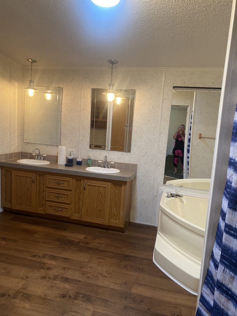 Bathroom with double sinks and a tub.