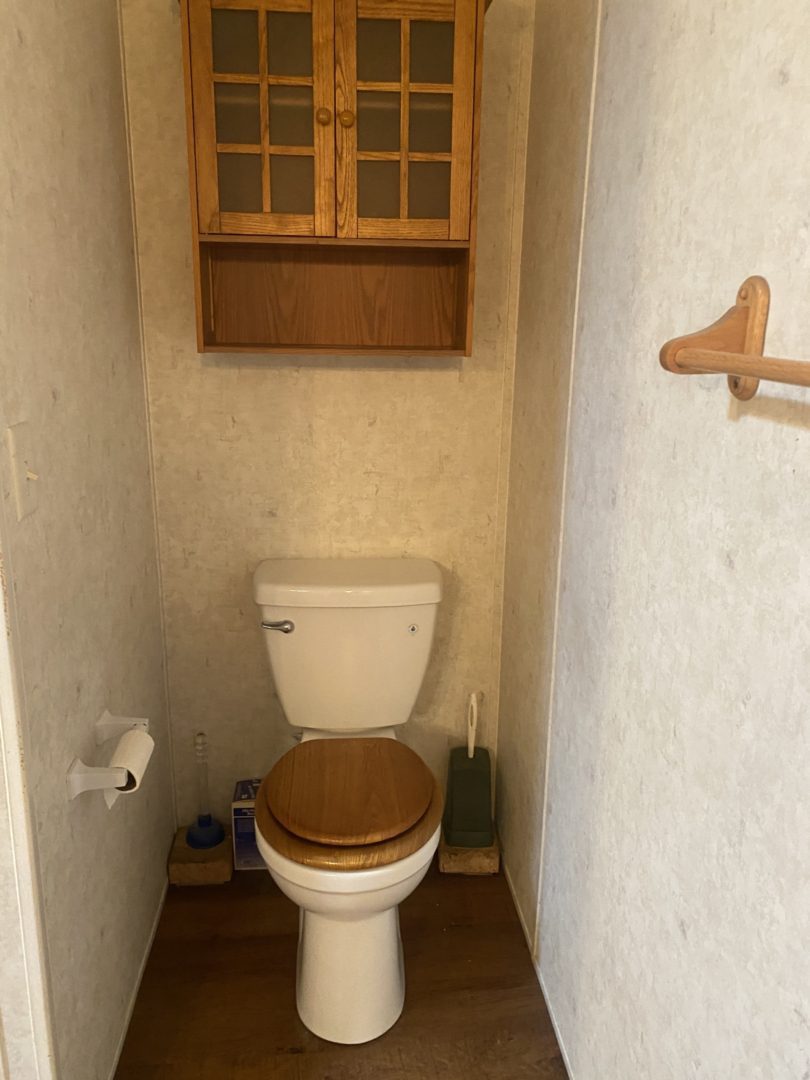 A white toilet in a small bathroom.