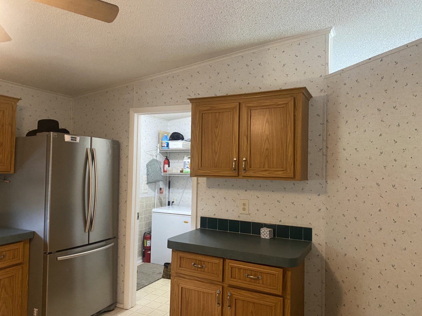 Kitchen with stainless steel refrigerator and cabinets.